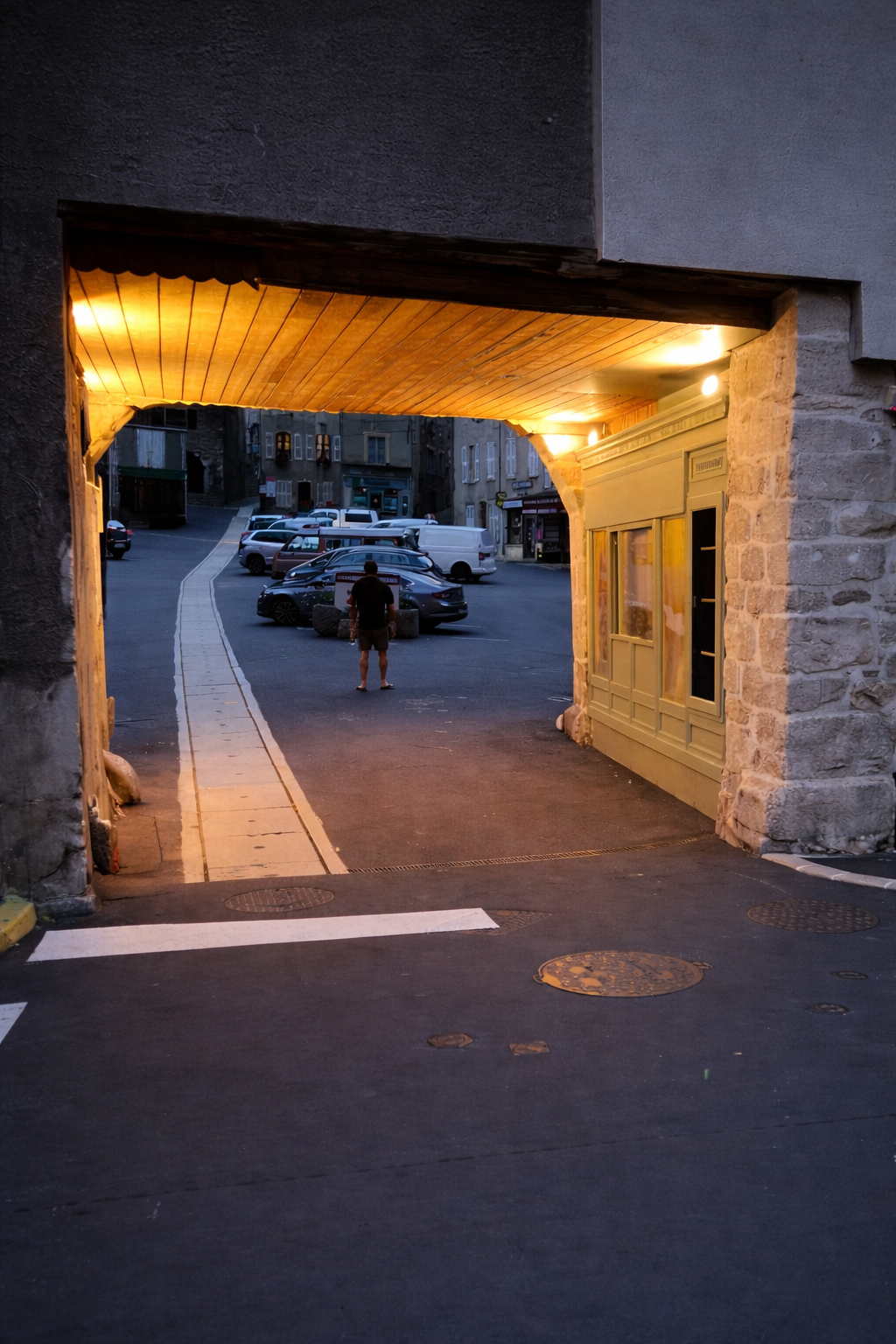 Porche éclairé marquant l’entrée de la place du marché à Chaudes-Aigues
