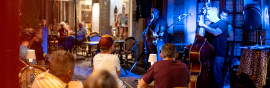 Concert des Terrasses Musicales à Chaudes-Aigues devant Gourmet & Glouton avec public en terrasse et musique live dans le centre-bourg